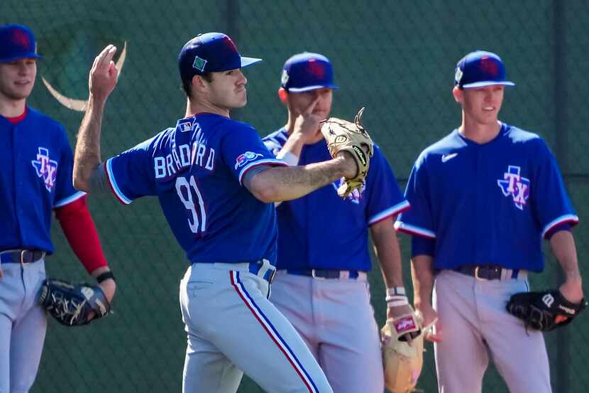 Pitcher Cody Bradford participates in a drill during a Texas Rangers minor league spring...