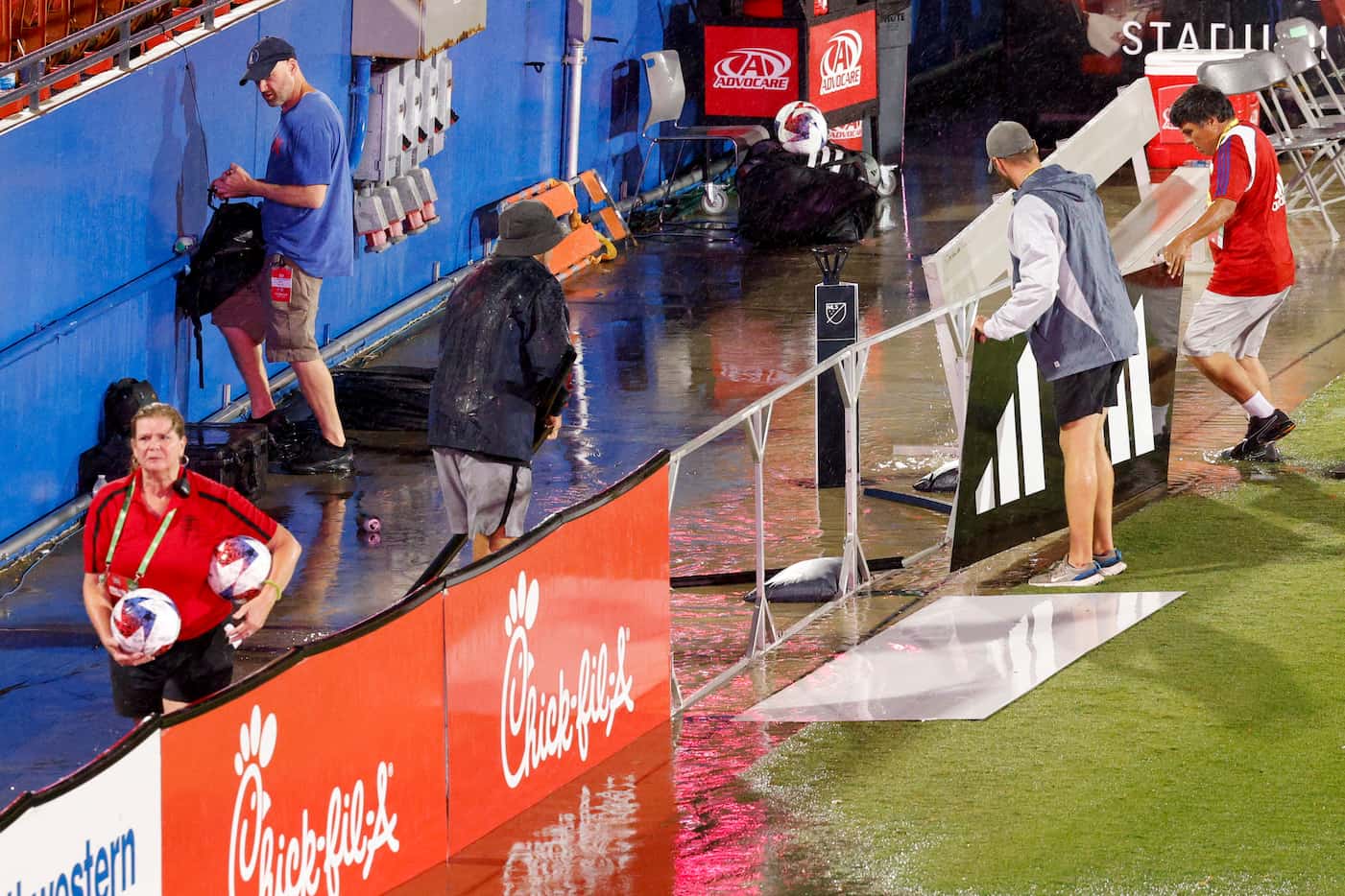 Toyota Stadium staff pickup signage that had fallen as a severe thunderstorm moved in during...