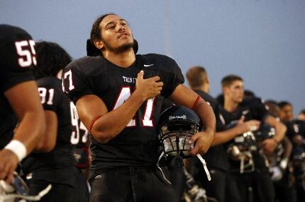  Euless Trinity linebacker Elikena "Eric" Fieilo (47) stands during the National Anthem...