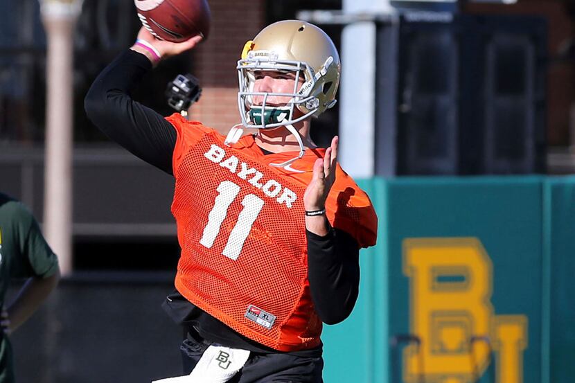 Baylor quarterback Zach Smith throws downfield during the first day of NCAA college football...