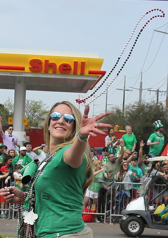 Beads are thrown to spectators along the parade route during the Dallas St. Patrick's Parade...