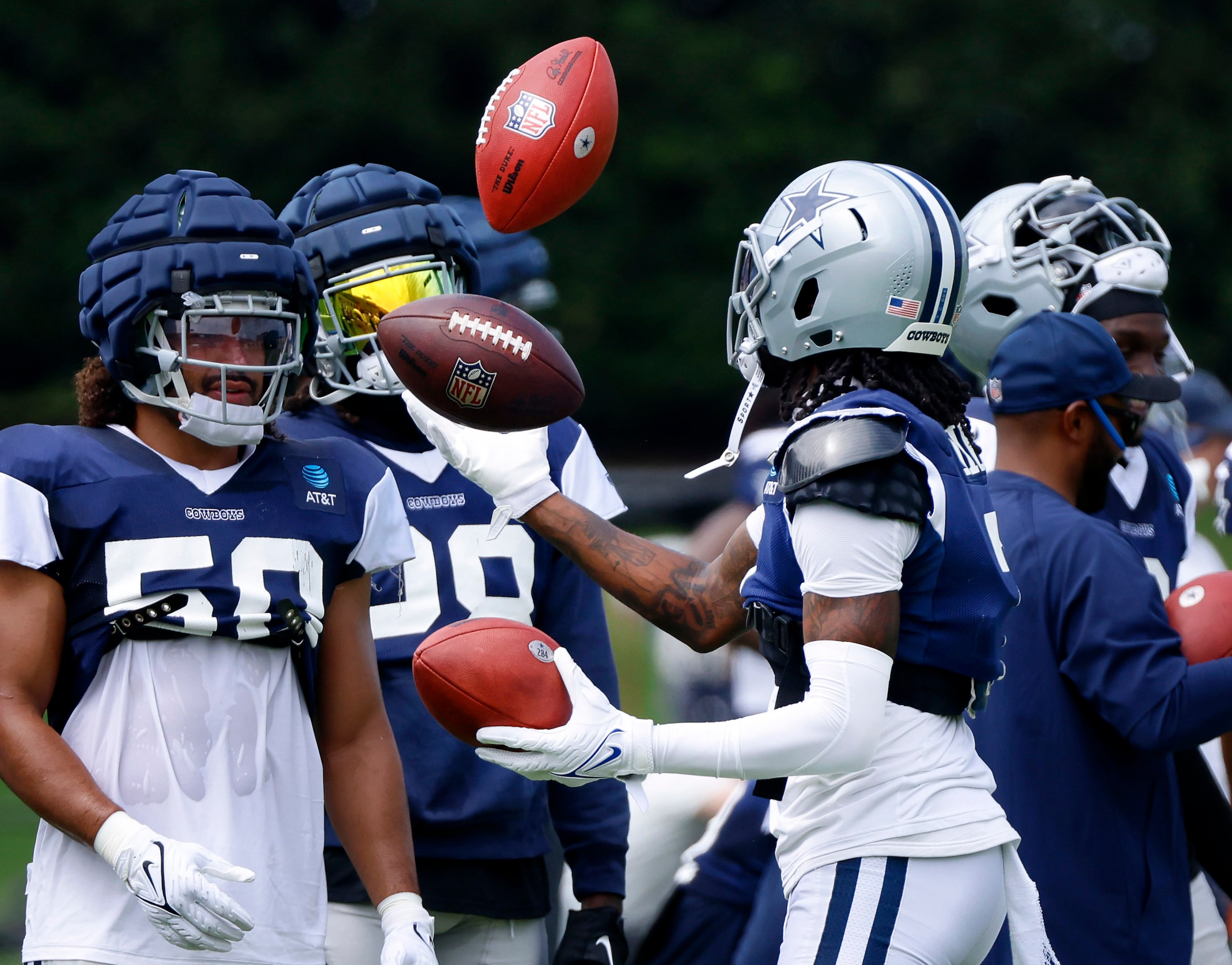 Dallas Cowboys cornerback Trevon Diggs (7) juggles three footballs on the sideline as the...