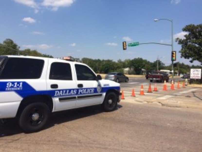  A police car barricades the 3900 block of Bluffview Boulevard Tuesday afternoon.Â 