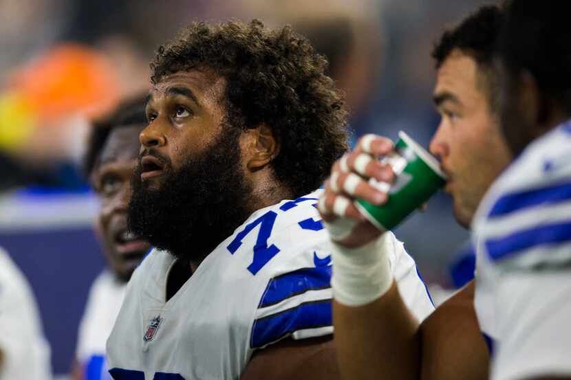 Dallas Cowboys center Joe Looney (73) sits on the bench during the second quarter of an NFL...