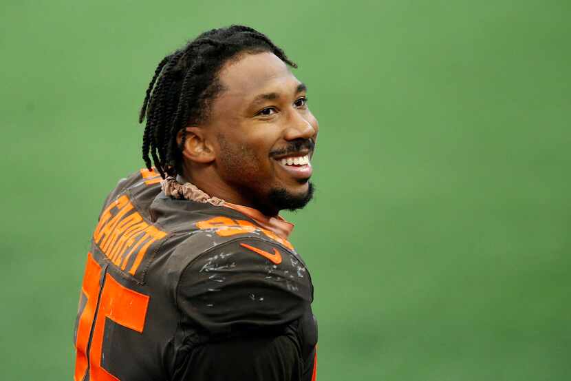 Cleveland Browns defensive end Myles Garrett (95) of Arlington smiles to his family after...