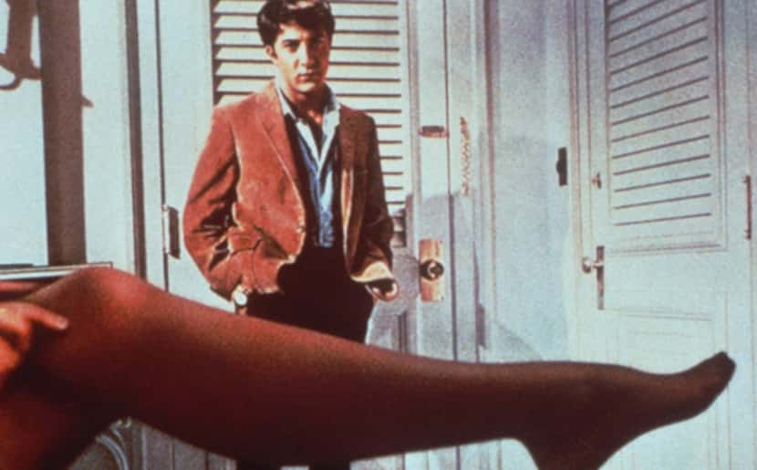 Benjamin Braddock (Dustin Hoffman) looks over the stockinged leg of Mrs. Robinson (actress...
