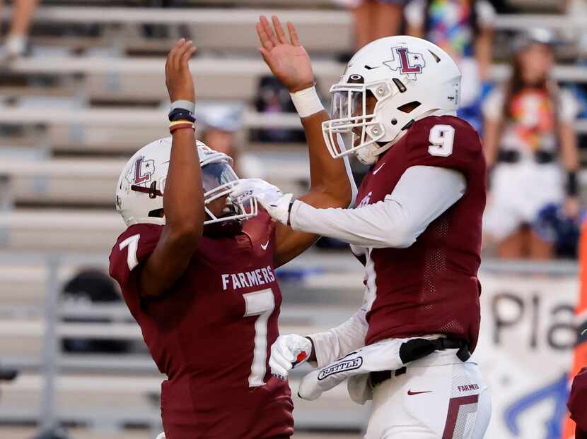 Lewisville quarterback Ethan Terrell (7) congratulates  Armani Winfield (9) after they...