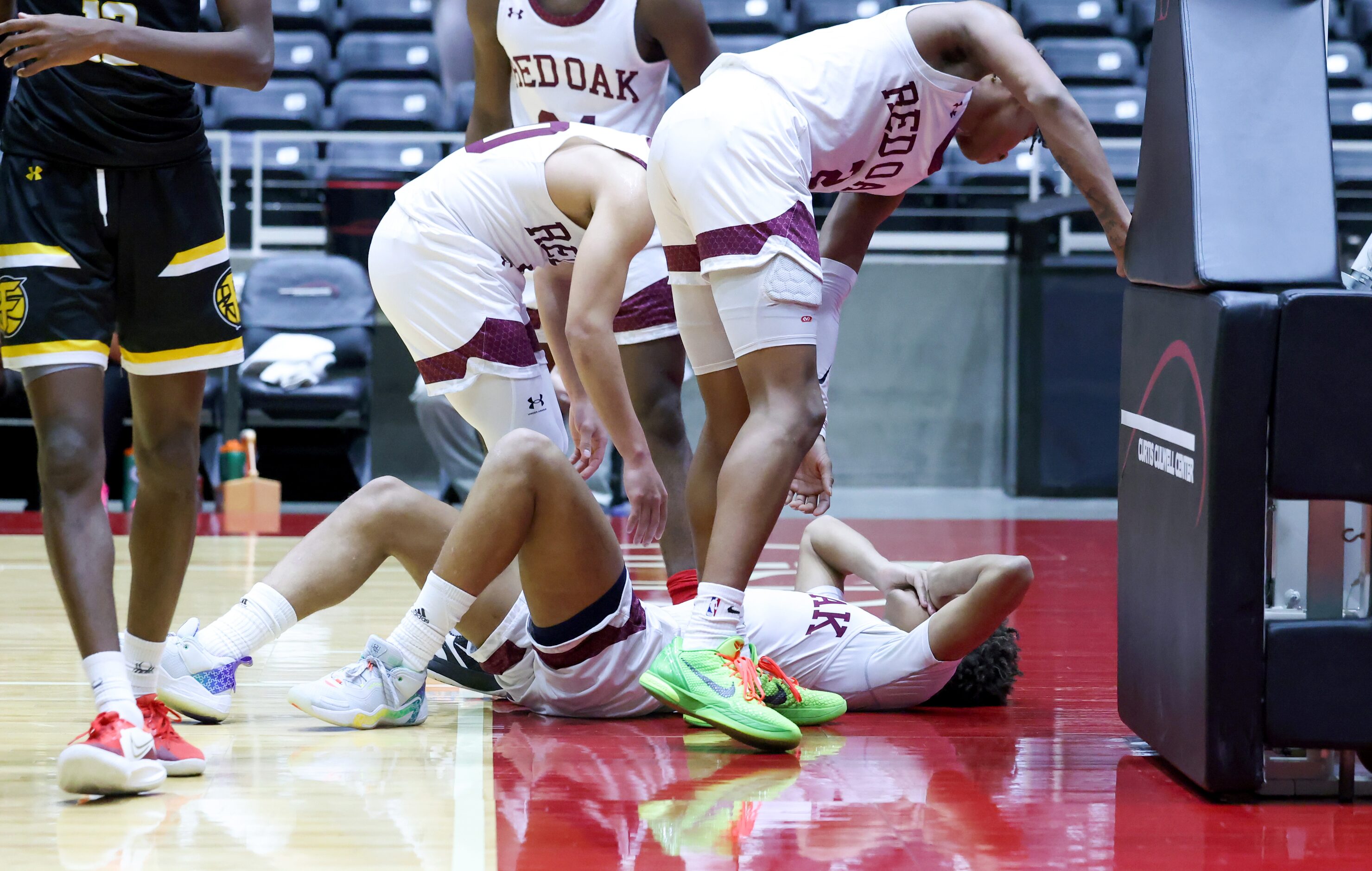 Red Oak senior guard Mark Broussard (00, left) and senior guard Jayden Murphy (2, right)...