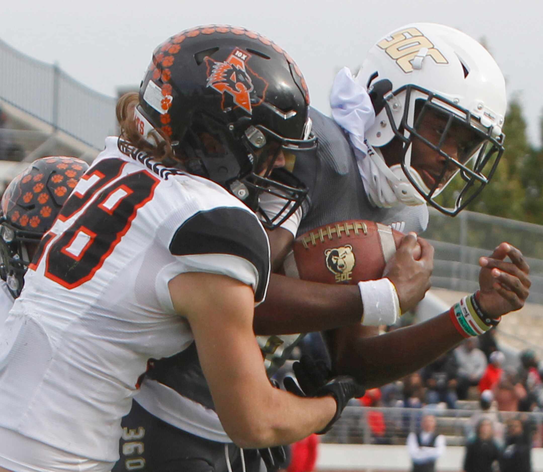 South Oak Cliff quarterback Kevin Henry-Jennings (8), right, forces his way into the end...