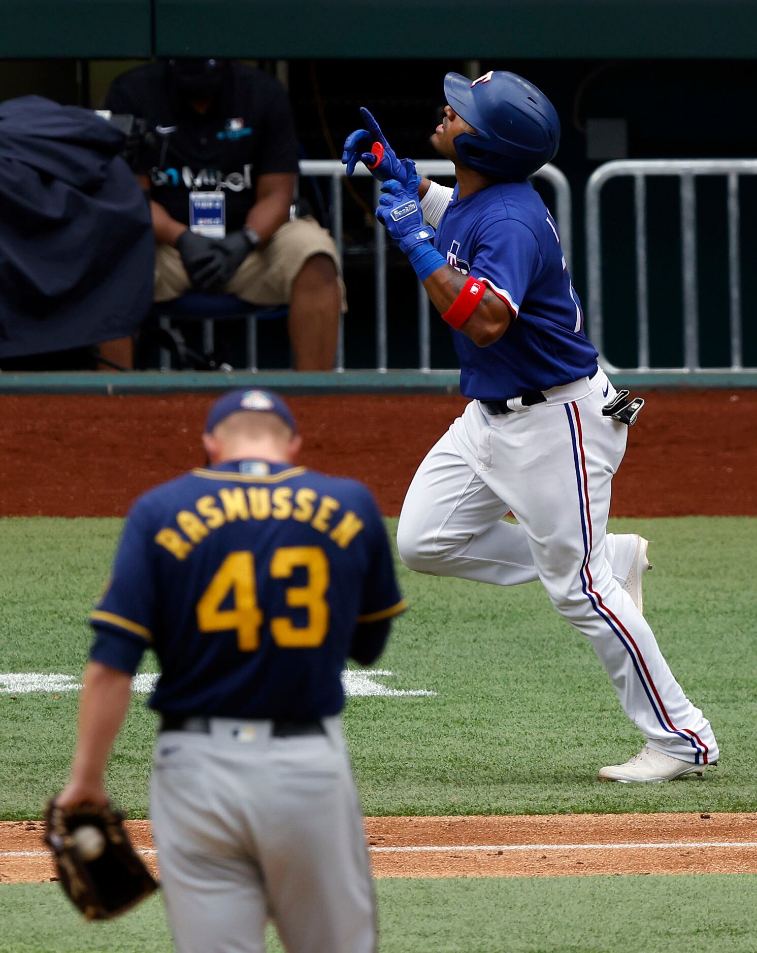 Texas Rangers batter Andy Ibáñez looks skyward after hitting a solo home run in the eighth...