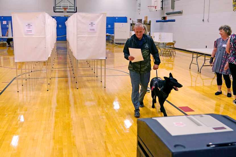 New Hampshire Republican U.S. Senate candidate Don Bolduc carries his ballot before casting...