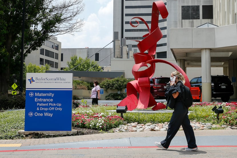 A worker walks outside the James M. & Darlene D. Collins Women & Children's Center at Baylor...