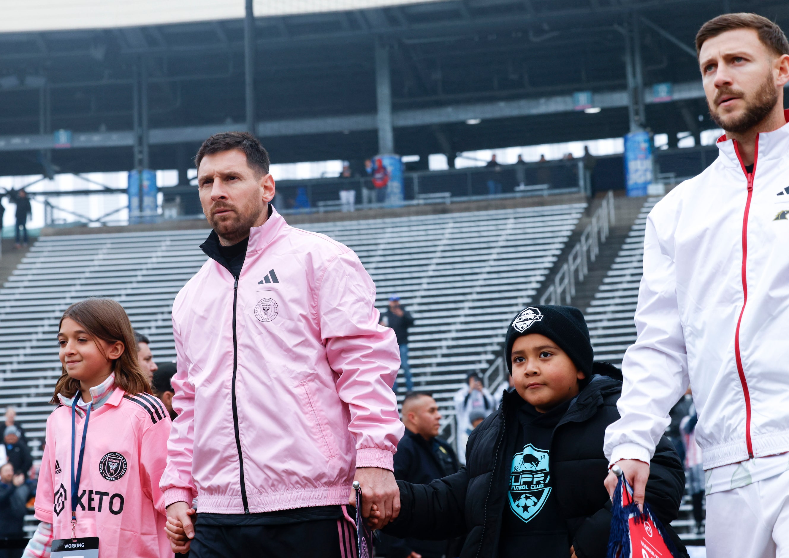 Inter Miami forward Lionel Messi (left) and FC Dallas forward Paul Arriola takes the field...