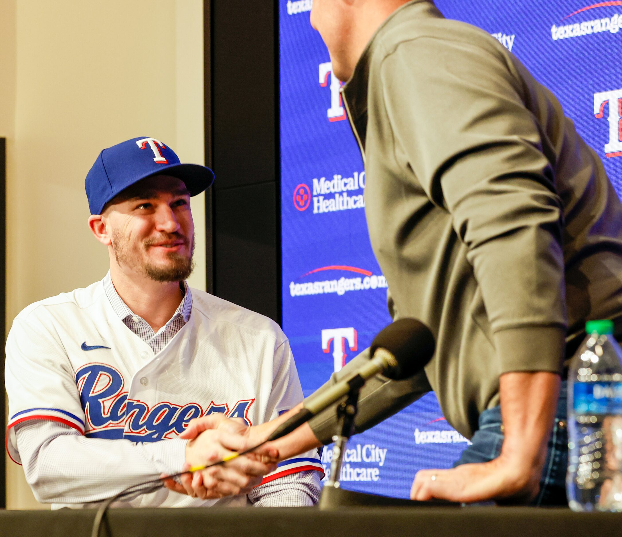 New Texas Rangers pitcher Andrew Heaney (left) shakes hands with general manager Chris Young...