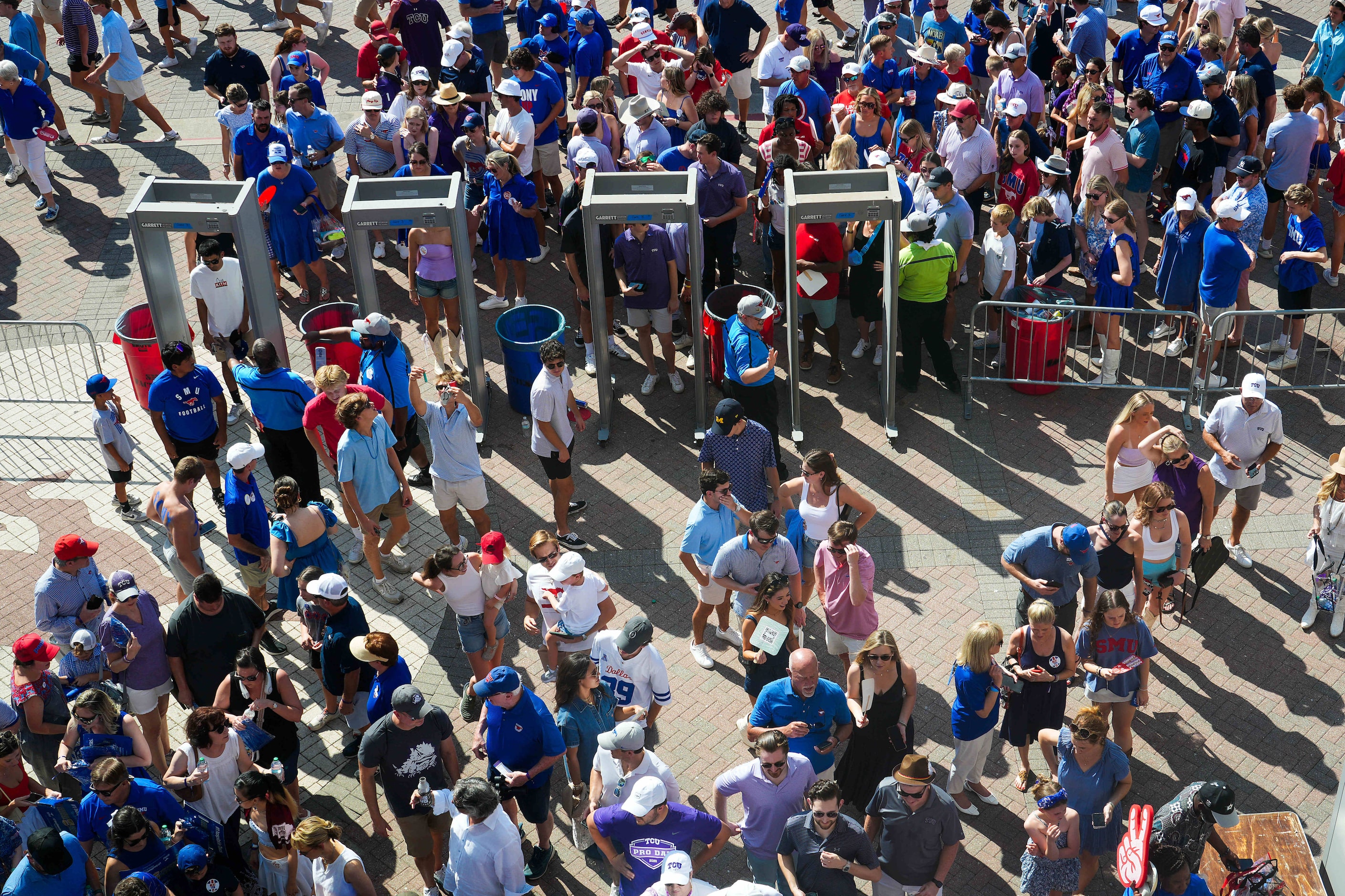 Fans go through security before an NCAA football game between SMU and TCU at Ford Stadium on...