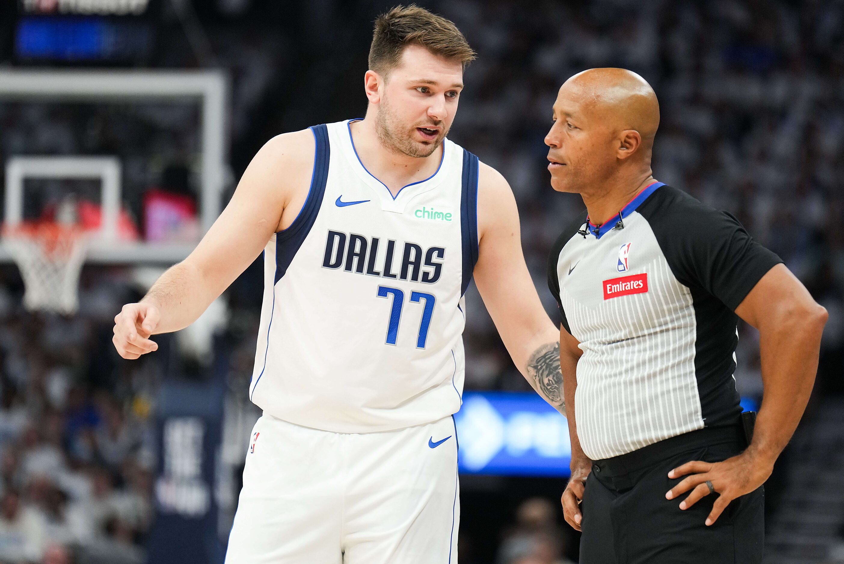 Dallas Mavericks guard Luka Doncic (77) talks with referee Marc Davis (8) during the first...