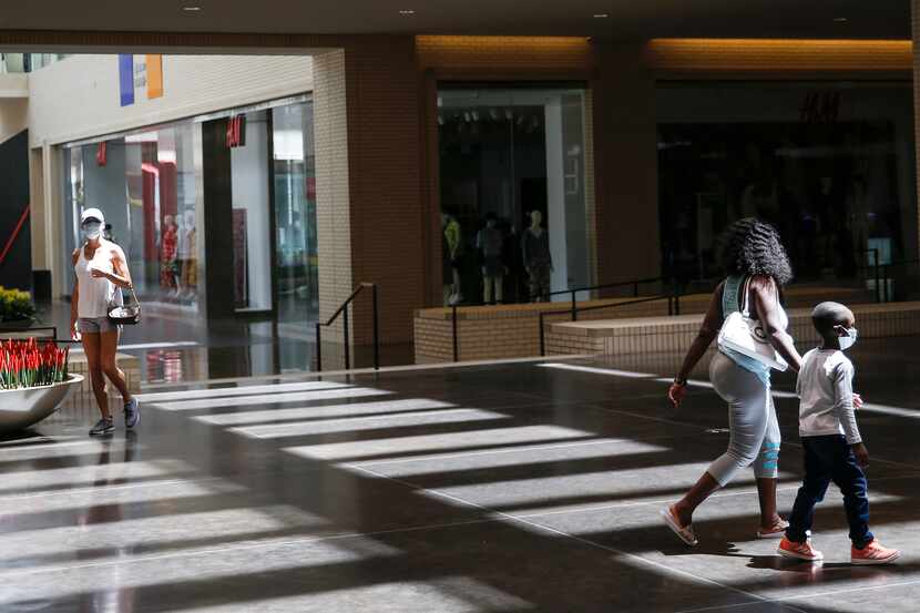 Shoppers walk through NorthPark Center mall on Friday, May 1, 2020 in Dallas, Texas. Texas...