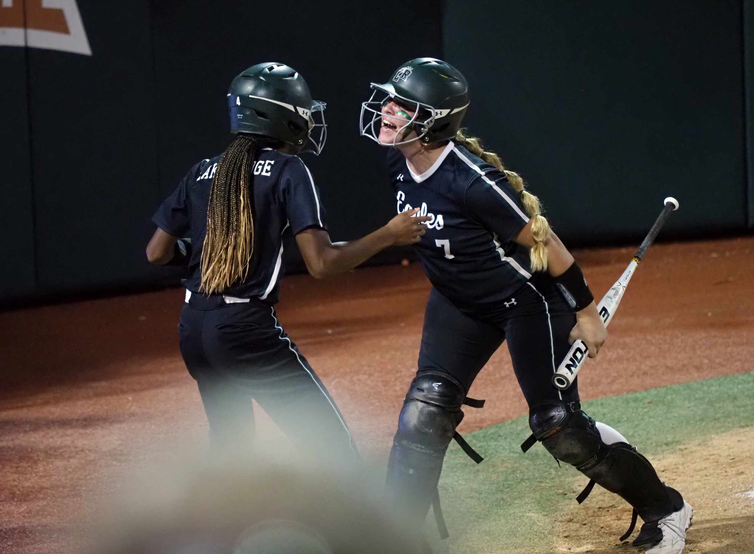 Mansfield Lake Ridge batter Reign Brannon (right) and baserunner Kassidy Chance (left) react...