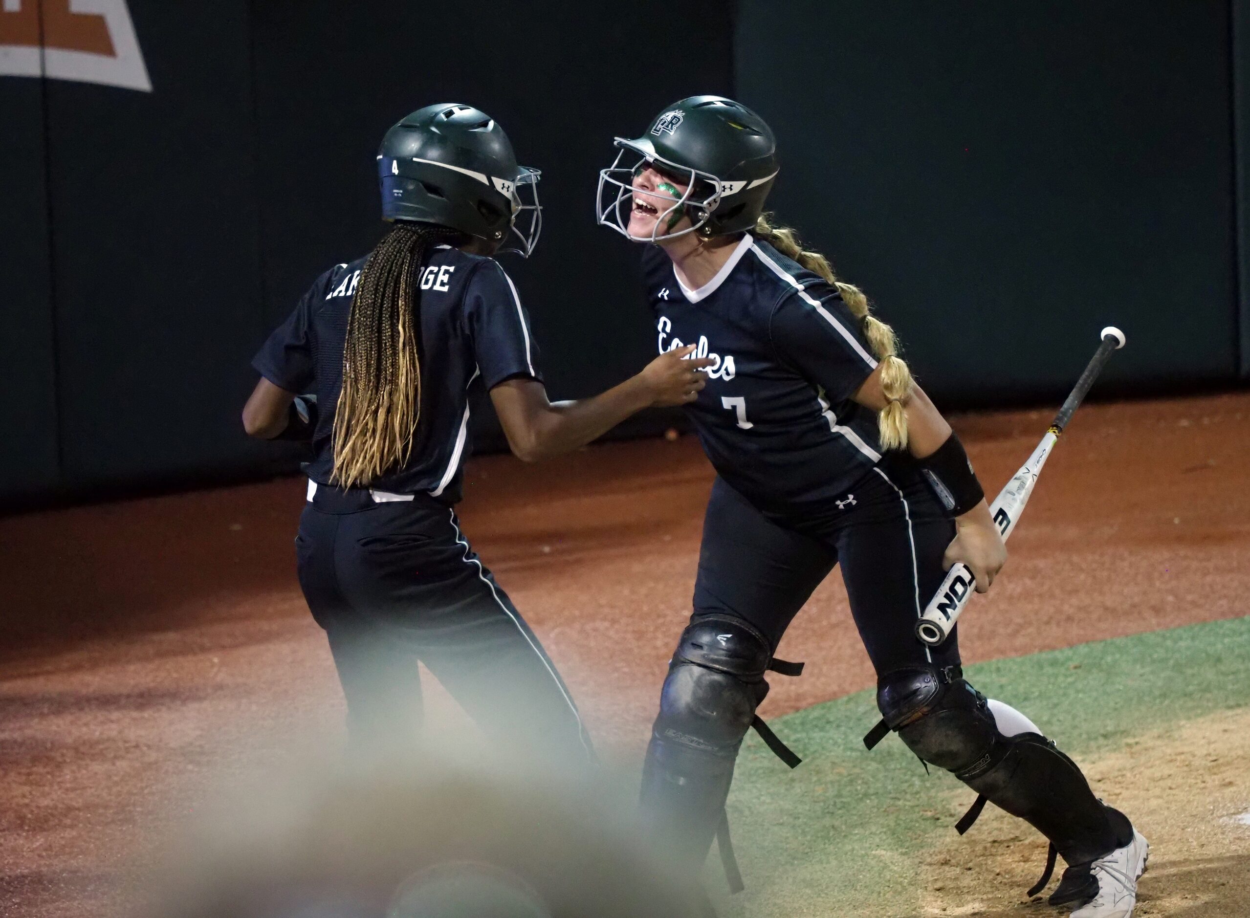 Mansfield Lake Ridge batter Reign Brannon (right) and baserunner Kassidy Chance (left) react...