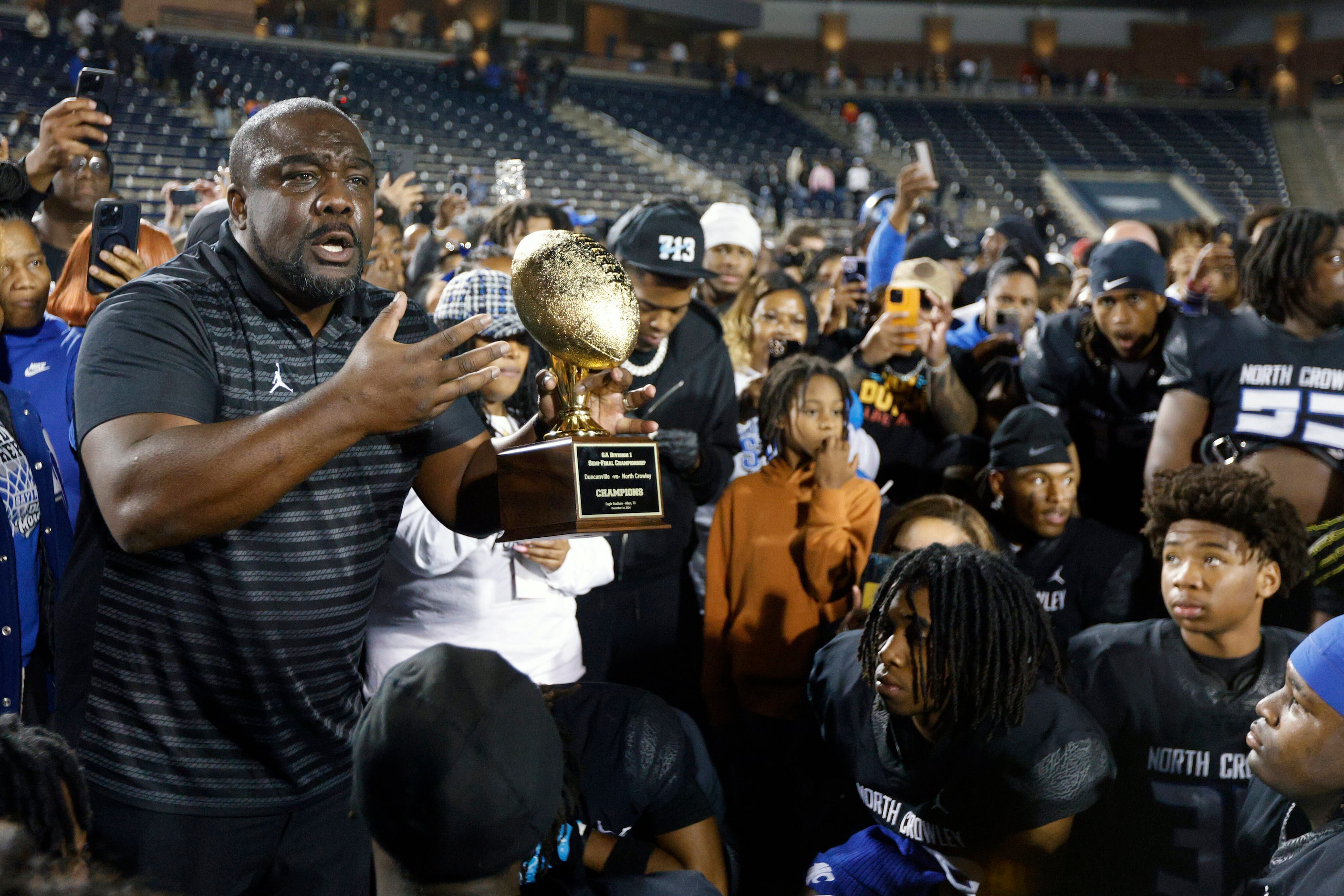 North Crowley head coach Ray Gates speaks to his team after winning a Class 6A Division I...