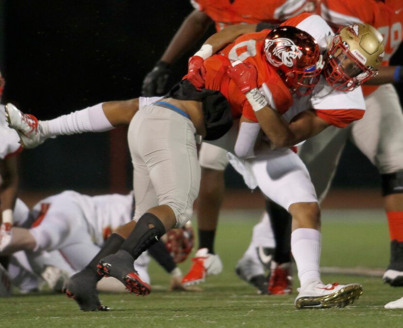 South Grand Prairie linebacker Myles Jernigan (6) tackles Duncanville running back Trysten...