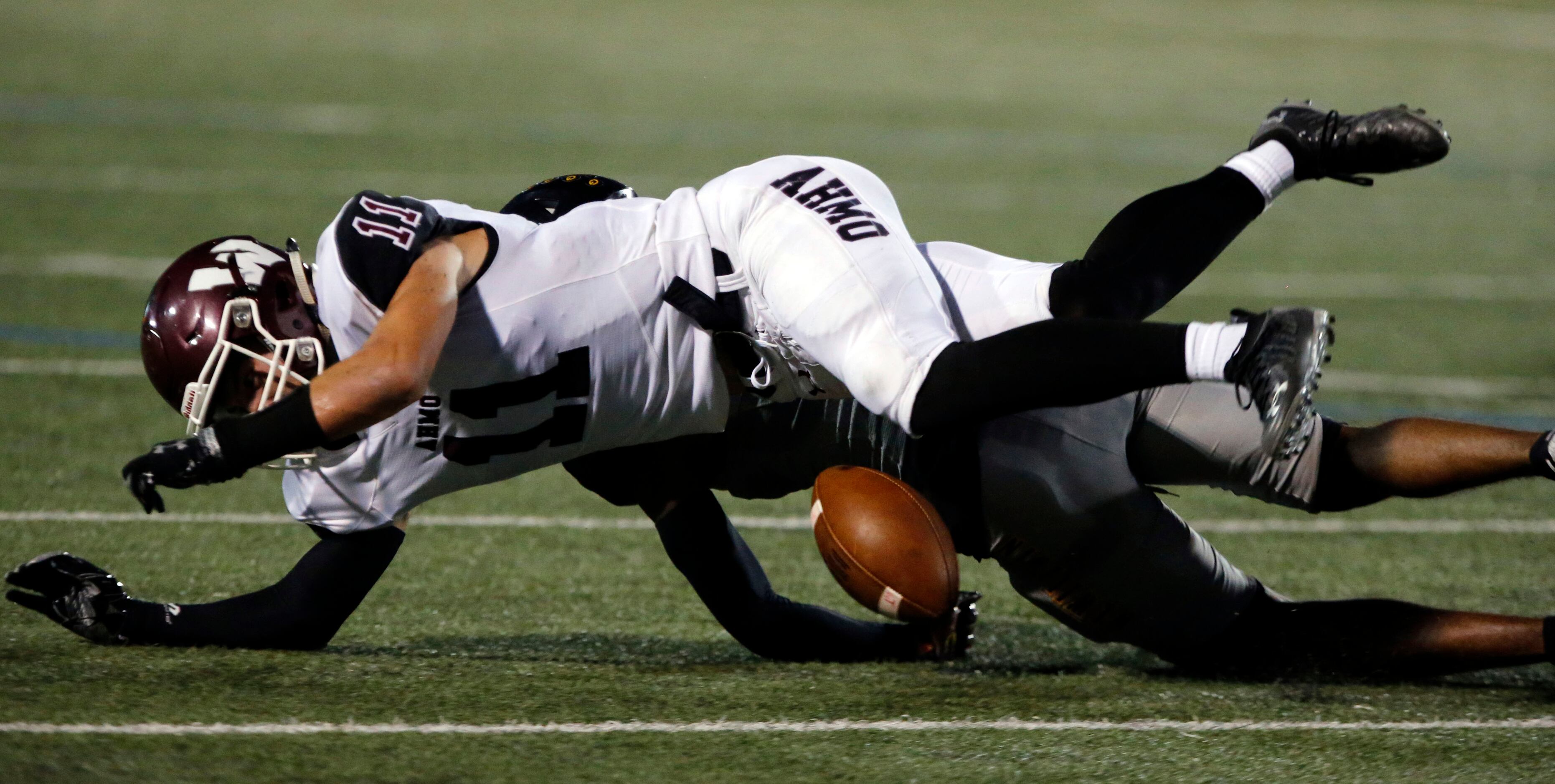 Wylie High’s Canyon Hall (11) and Garland high Ellis Rogers (8) battle for a loose ball that...