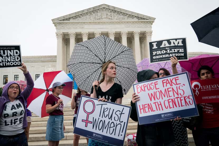 Activists demonstrate outside the U.S. Supreme Court in Washington, June 22, 2018. (Erin...