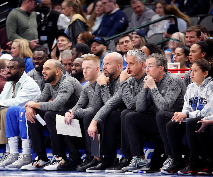 Dallas Mavericks assistant coaches (from left, in grey) Jared Dudley, Sean Sweeney, head...