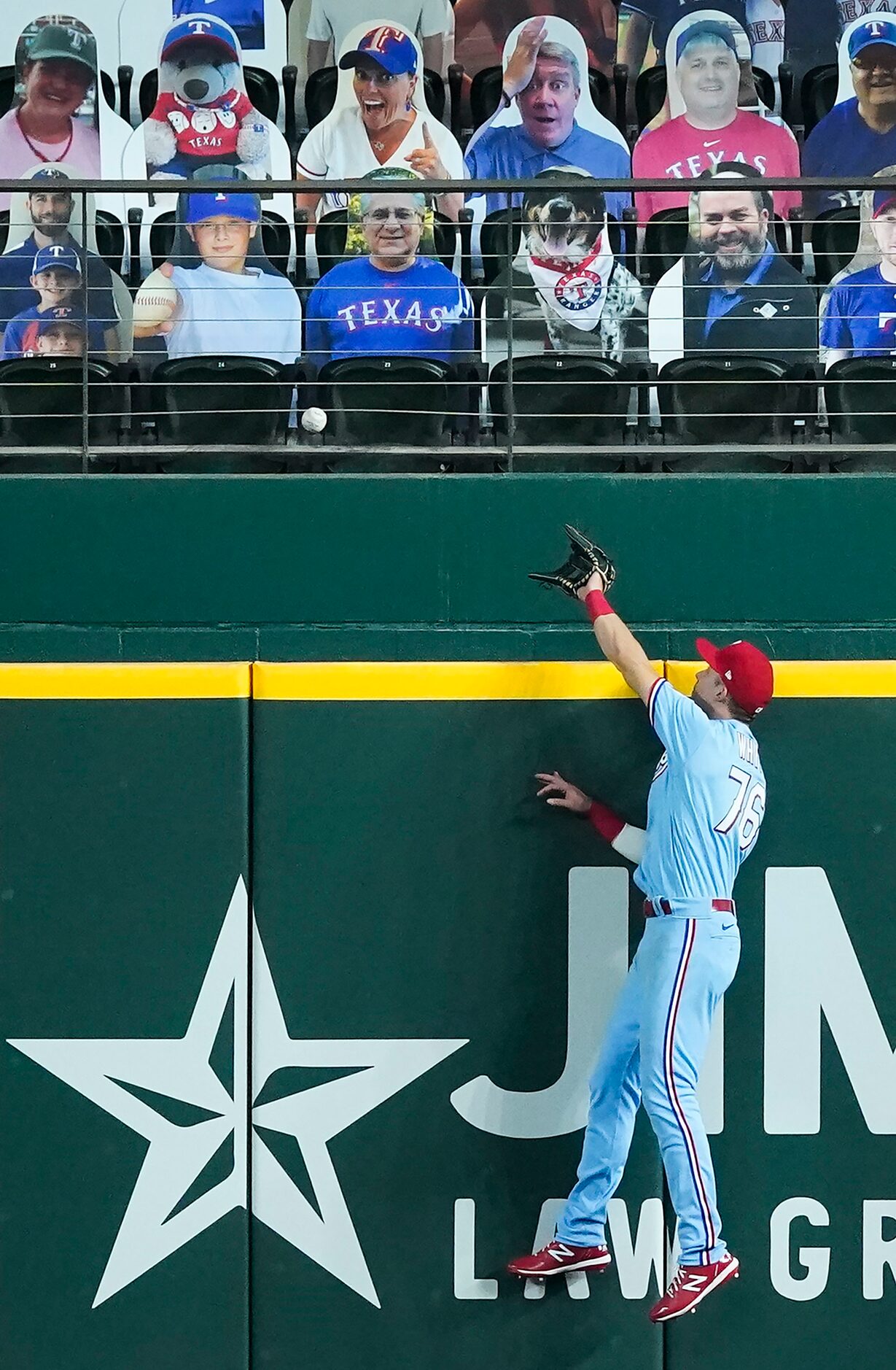 Texas Rangers right fielder Eli White can’t make the play on a home run off the bat of...