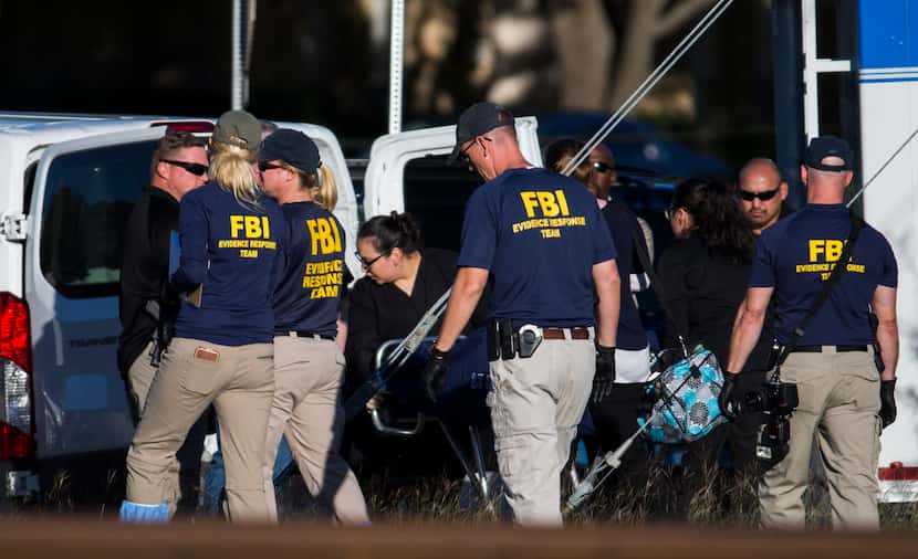 A body is removed from the area where it was found on Sunday, October 22, 2017, at the...
