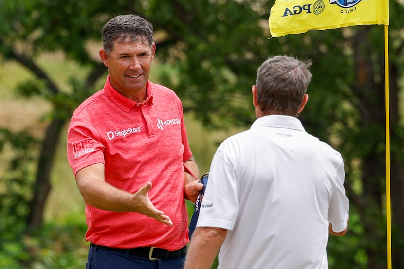 Padraig Harrington of Ireland (left) shakes hands with Steven Alker of New Zealand after the...