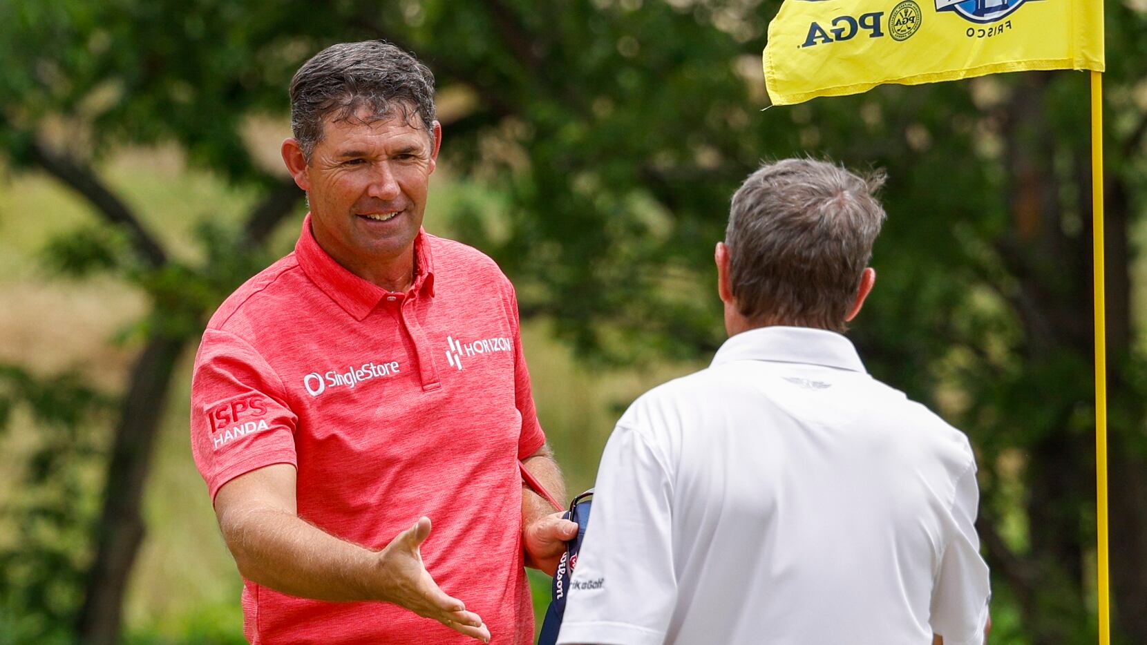 Padraig Harrington of Ireland (left) shakes hands with Steven Alker of New Zealand after the...