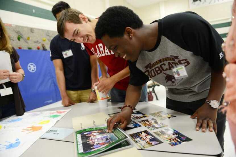 
Graduating seniors Peter Darwin (left) and Joseph Jackson look at class photos during a...