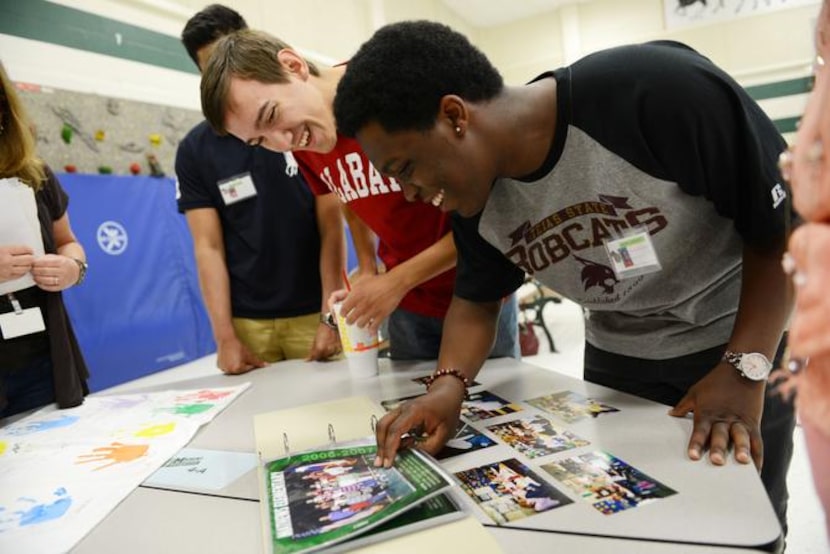 
Graduating seniors Peter Darwin (left) and Joseph Jackson look at class photos during a...