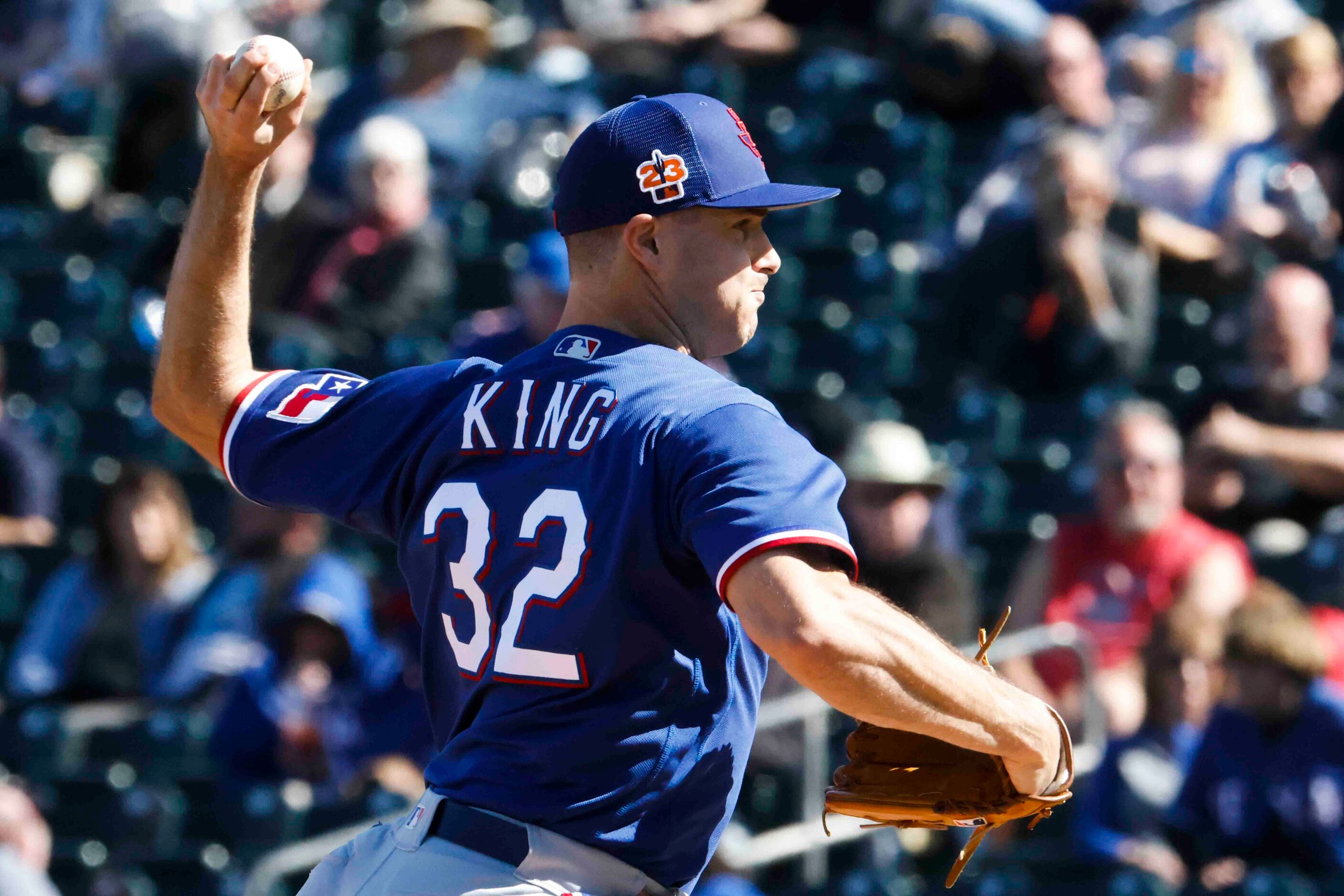 Texas Rangers John King throws during the fifth inning of a spring training game against the...