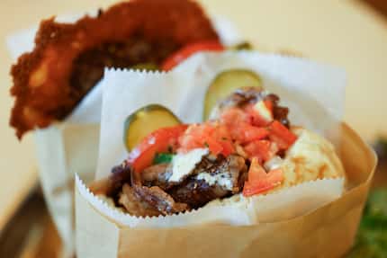 Rib-eye minute steak pita (front) and folded cheeseburger pita (back) are popular at other...