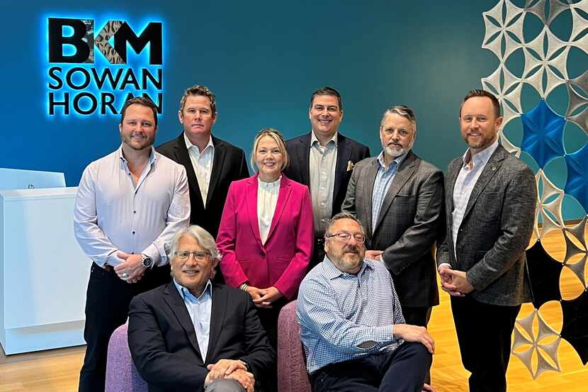 The BKM Sowan Horan team members at their Dallas office. Standing, left to right: Brian D....