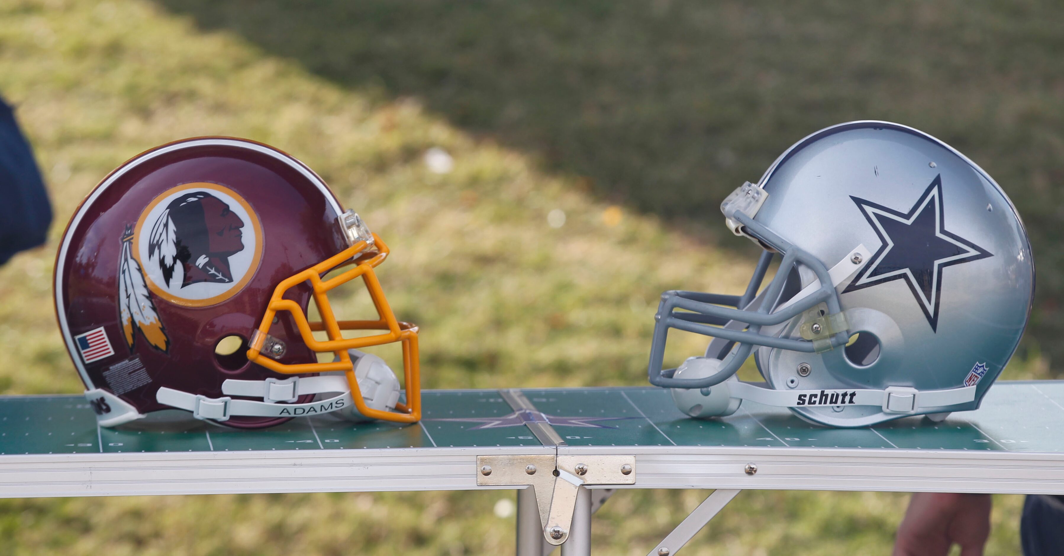 Football helments on display prior to the Dallas Cowboys-Washington Redskins NFL game at...