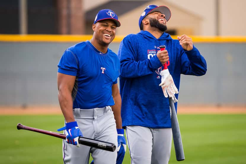 Texas Rangers third baseman Adrian Beltre (left) and shortstop Elvis Andrus laugh as they...