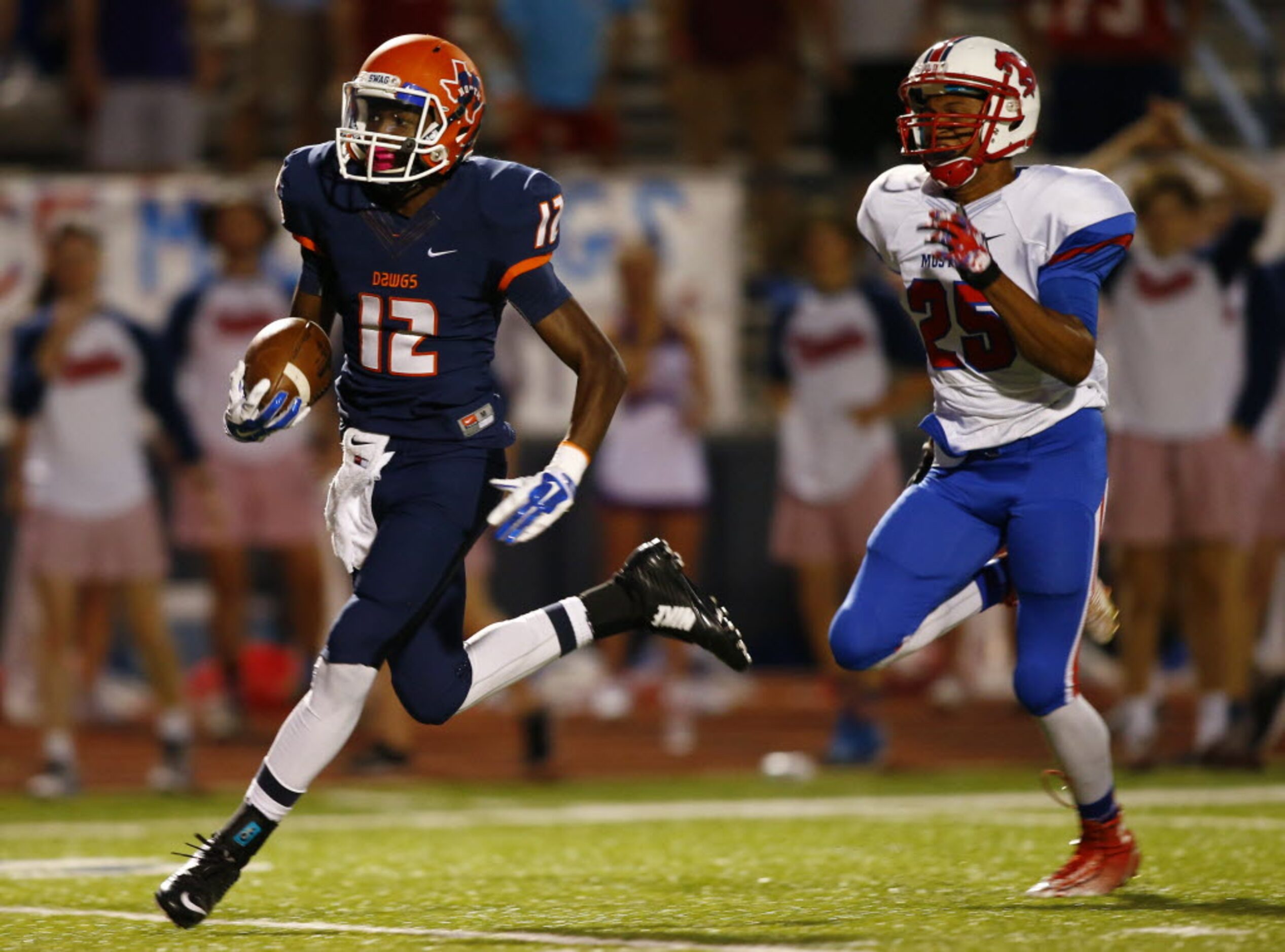 TXHSFB McKinney North wide receiver Miguel Hudson (12) races for a touchdown after catching...