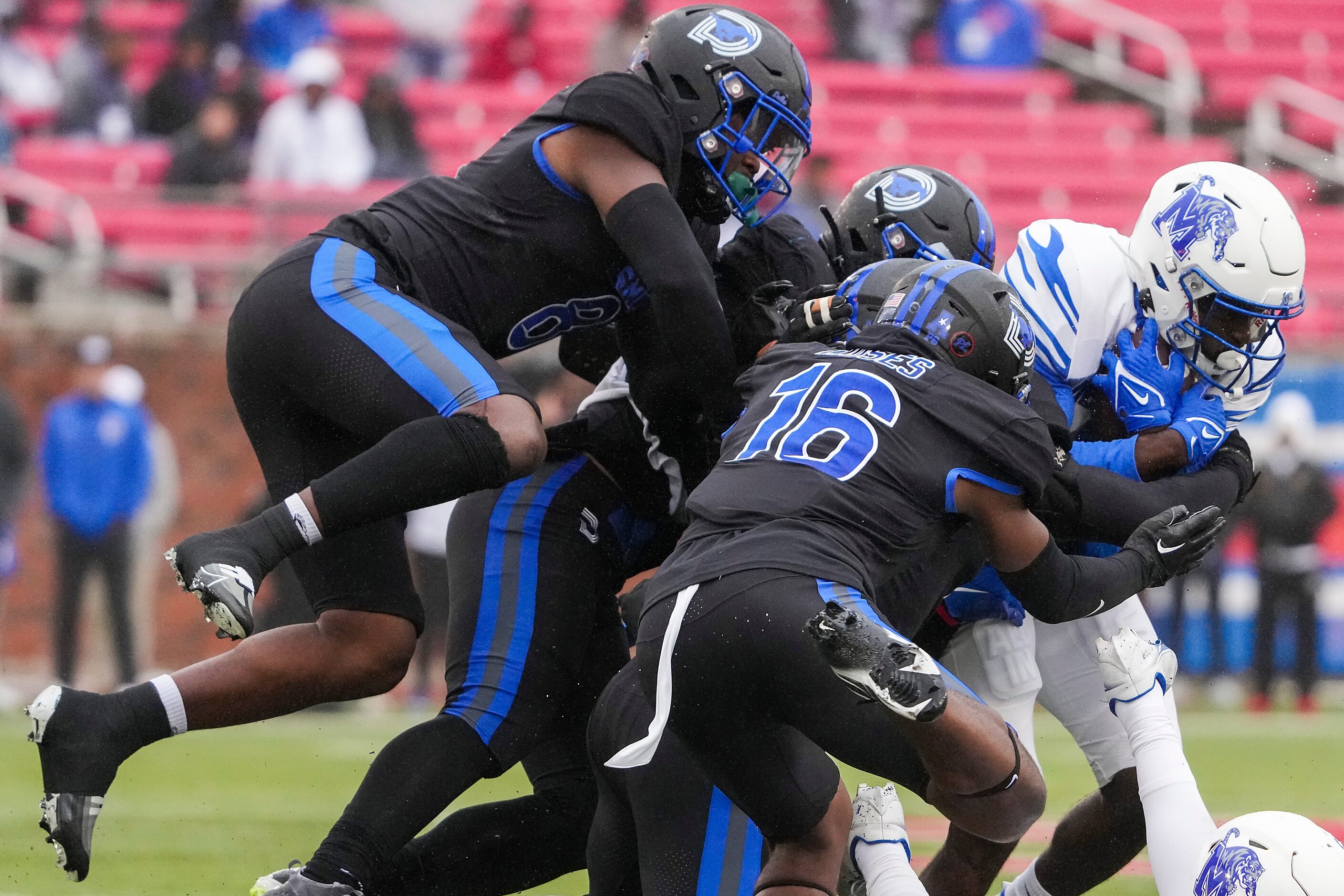 Memphis wide receiver Gabriel Rogers (9) is brought down by SMU safety Ahmaad Moses (16),...