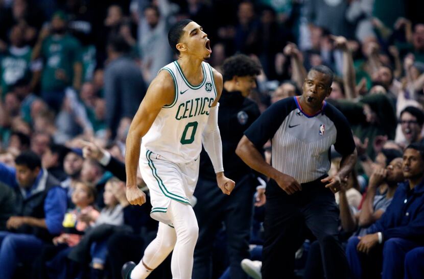 Boston Celtics' Jayson Tatum reacts after scoring during the fourth quarter of an NBA...