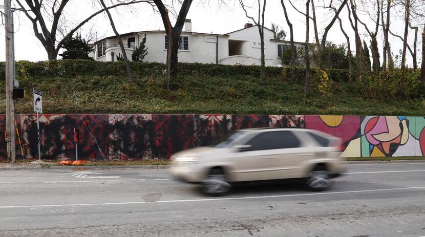 A motorist passes by the painted-over Shepard Fairey murals, which were vandalized with...