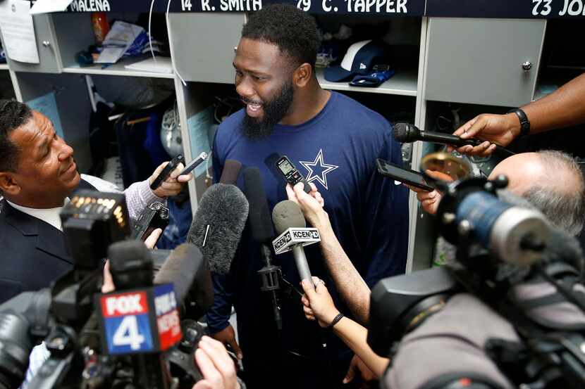 Cowboys rookie defensive end Charles Tapper talks with the media in a locker room during the...