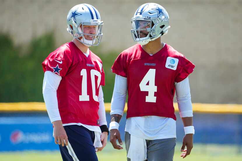 Dallas Cowboys quarterback Dak Prescott (4) talks with quarterback Cooper Rush (10) during...