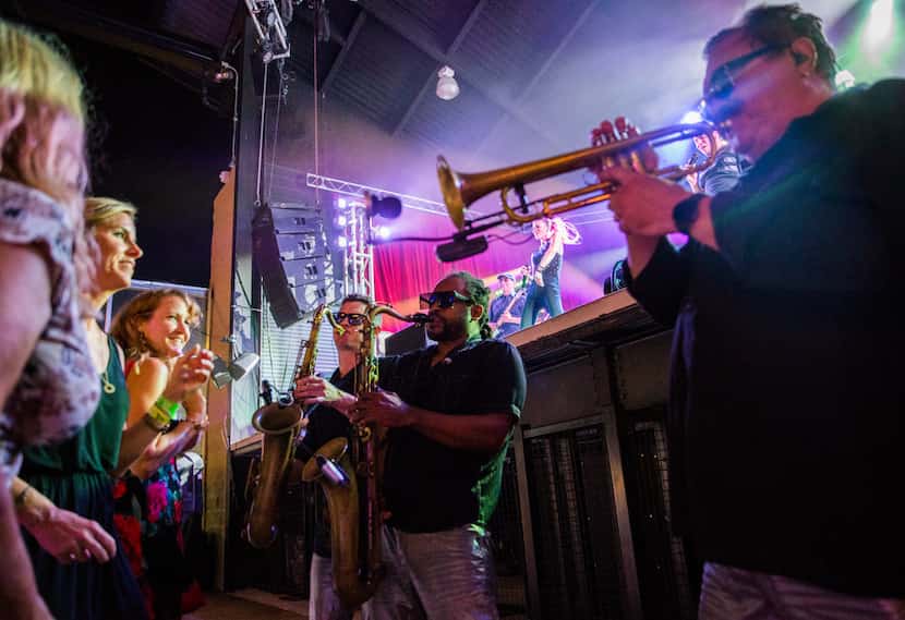 The horns section danced and weaved in and out of the crowd during the band's performance at...