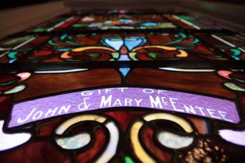 
The stained glass windows of Sacred Heart Catholic Church’s chapel list names of families...