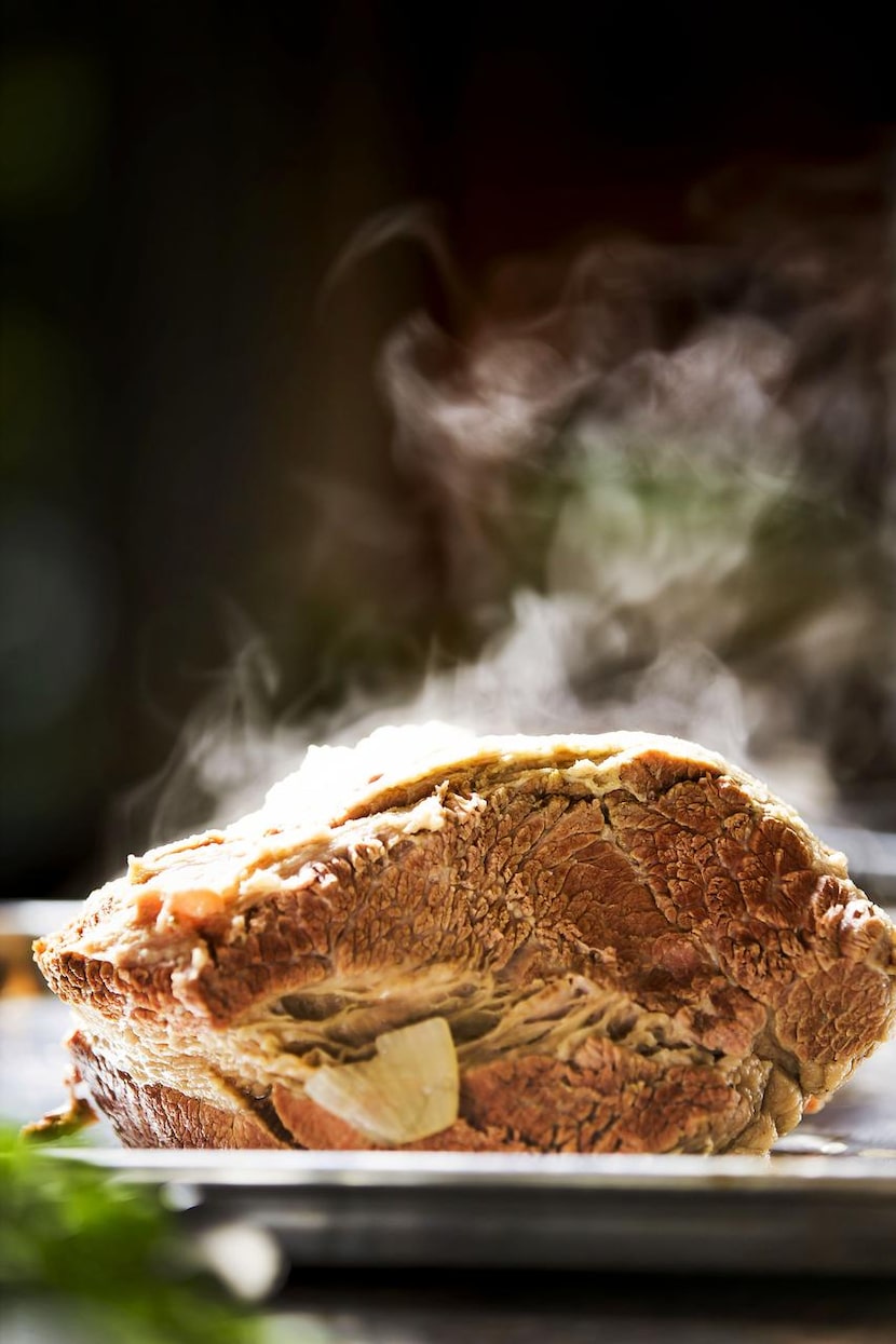 Steam rises from the brisket as Monica Greene prepares ropa vieja.