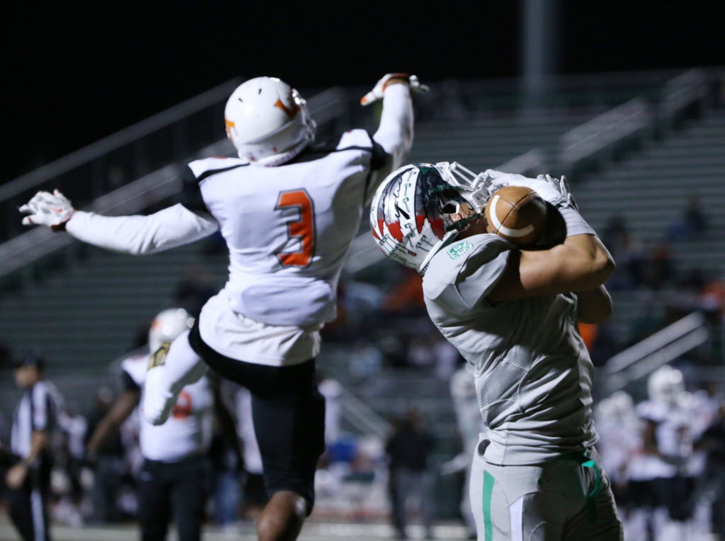 Waxahachie wide receiver Devan Brady (8) catches a pass over Kenan Ivy (3) in the first...