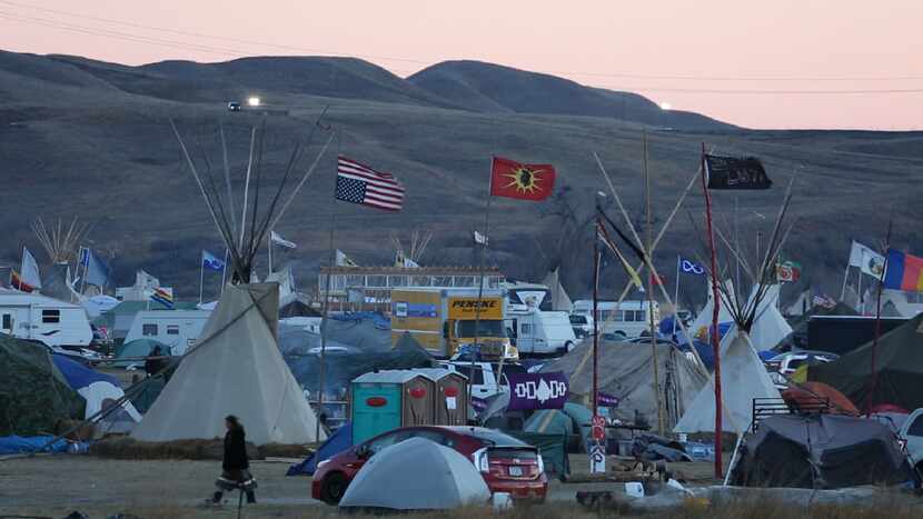 On a November day, the sun sets over the Oceti Sakowin protest camp which has become the...